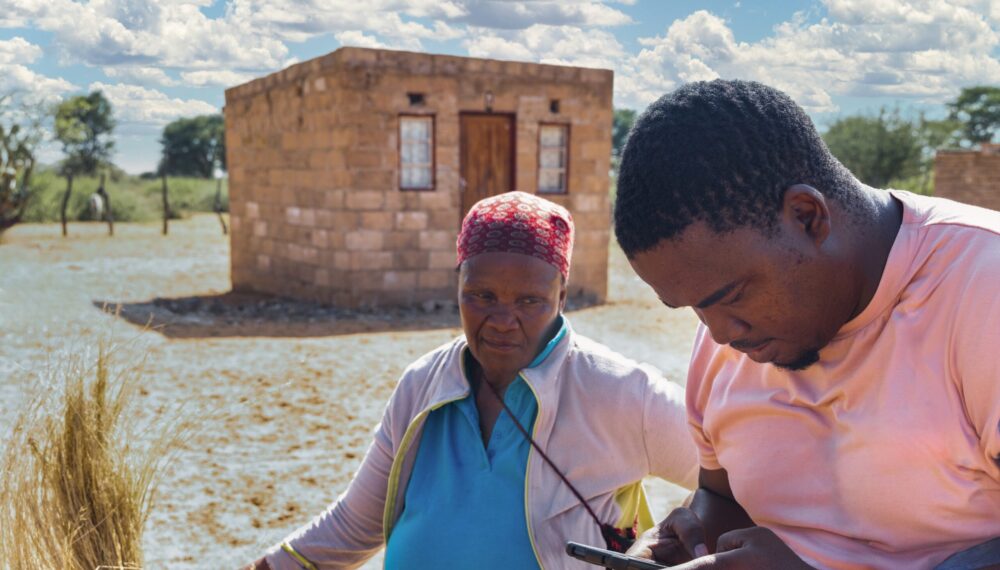 African,Village,,Old,Woman,Opening,In,Front,Of,The,House