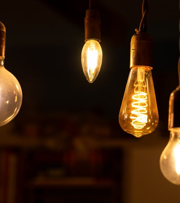 Retro LED light bulbs hanging on a dark background in interior. Electricity, Vintage