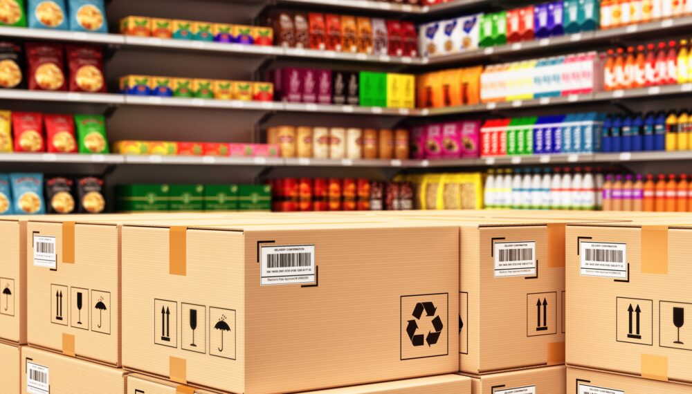 Stack of cardboard boxes in a retail store on the background of shelves with goods